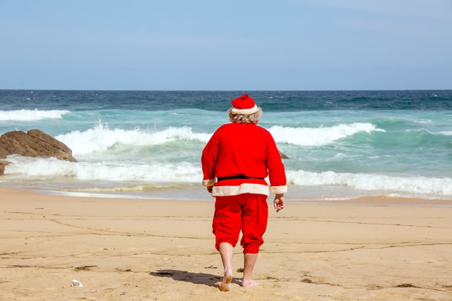 Santa heading down the beach for a swim. Image credit https://unsplash.com/photos/QyDLHeUerd4